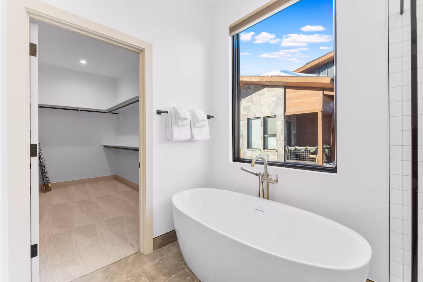 Freestanding tub beside window