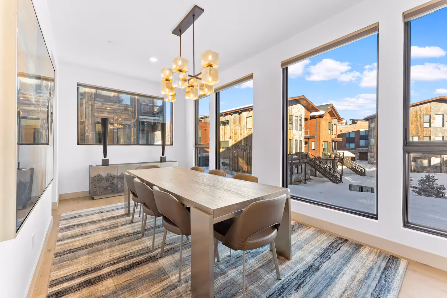 Dining area beside floor-to-ceiling windows
